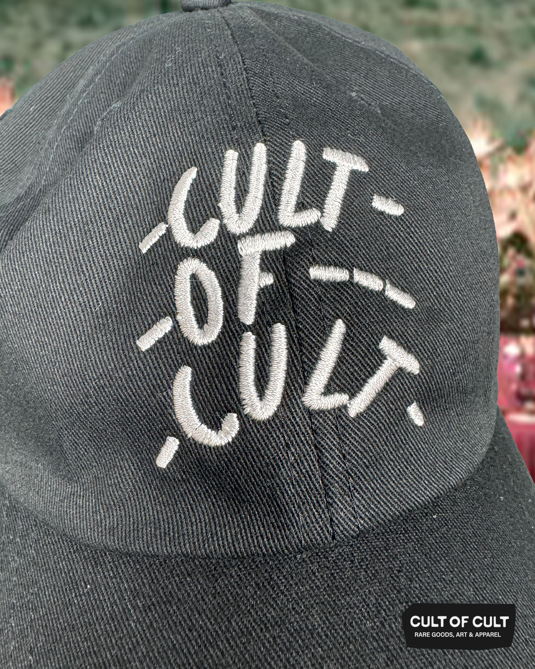 a front close up view of the front of the black Cult of Cult hat