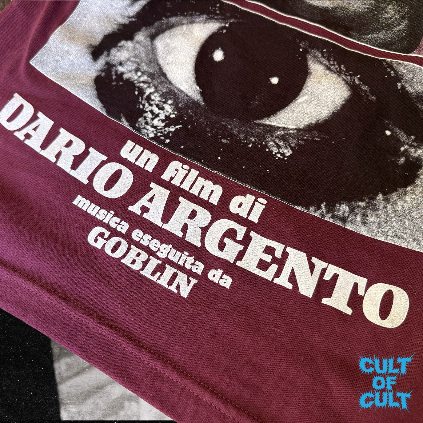A zoomed in detailed shot of the Deep Red Profondo Rosso 1975 short sleeve shirt that reads Dario Argento