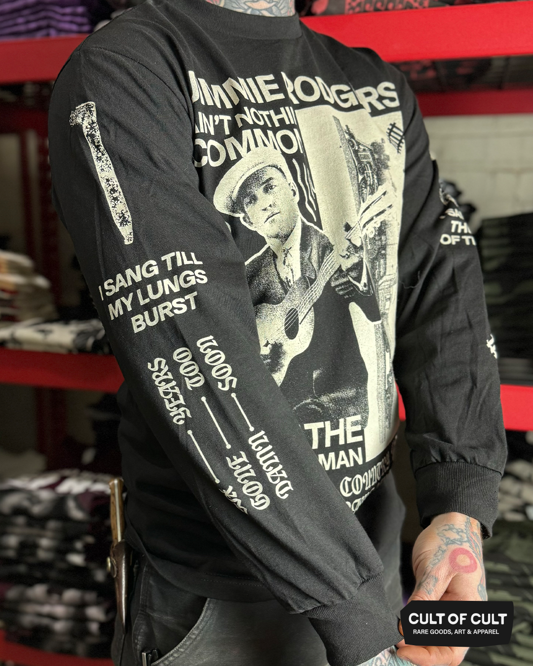 a model showing the sleeve print of the Jimmie Rodgers black long sleeve shirt