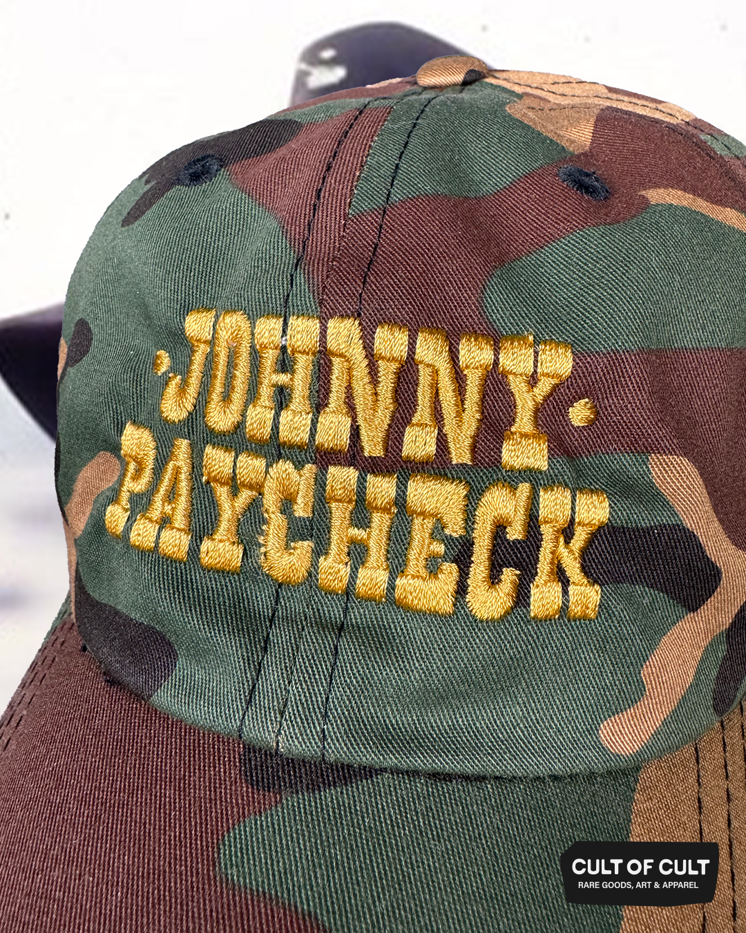 a close up detailed view of the camo Johnny Paycheck hat