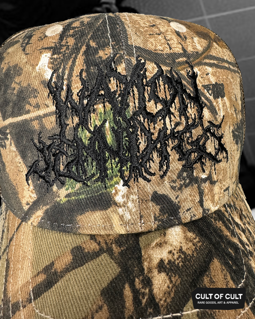 a close up view of the black brown and camo Waylon Jennings trucker hat
