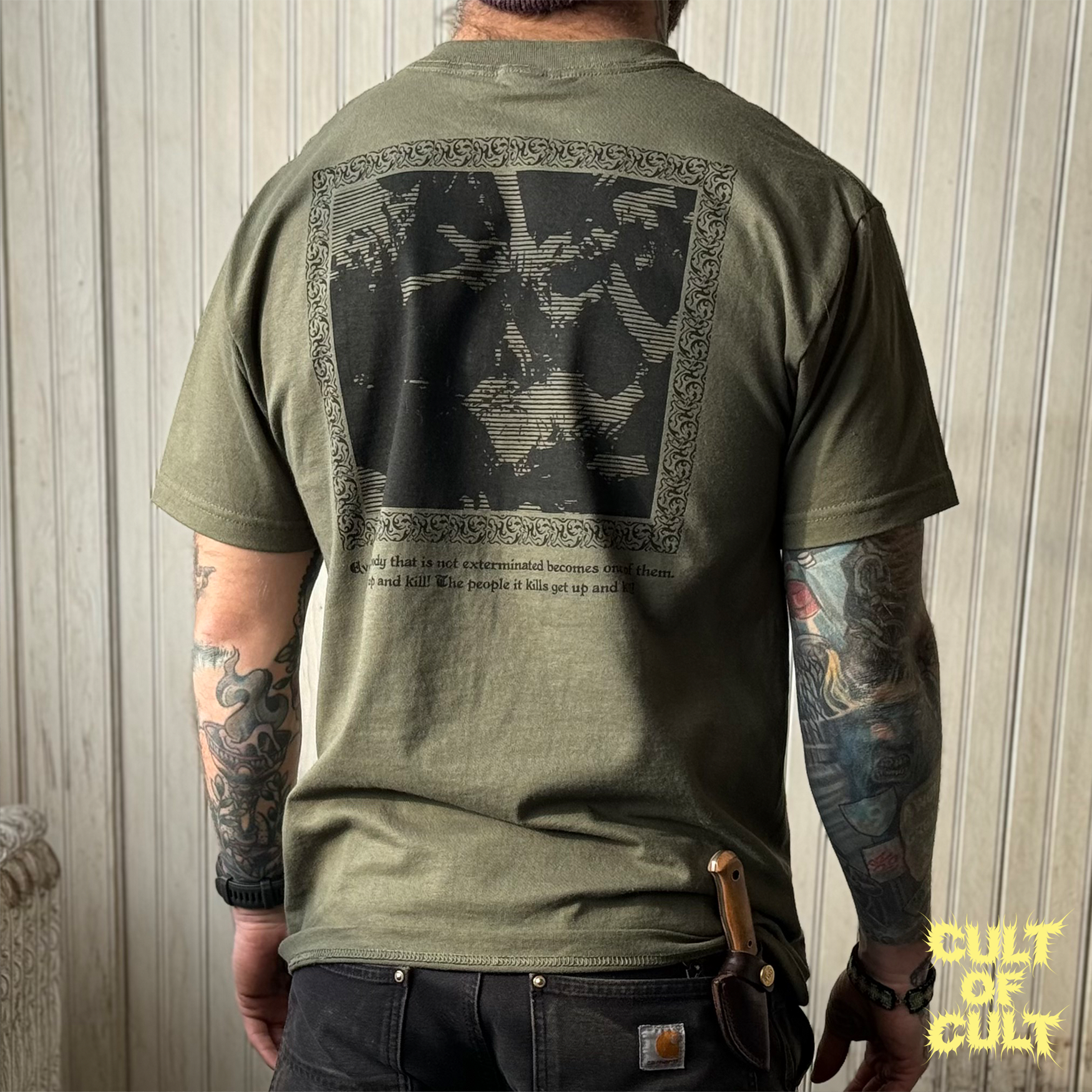 A model wearing the green Zombie Dawn of the Dead 1978 short sleeve shirt pictured from the back