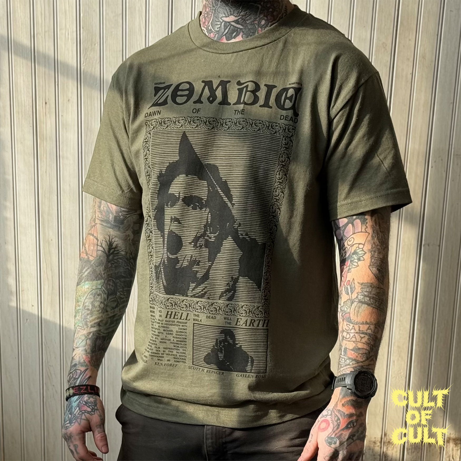 A model wearing the green Zombie Dawn of the Dead 1978 short sleeve shirt pictured from the front